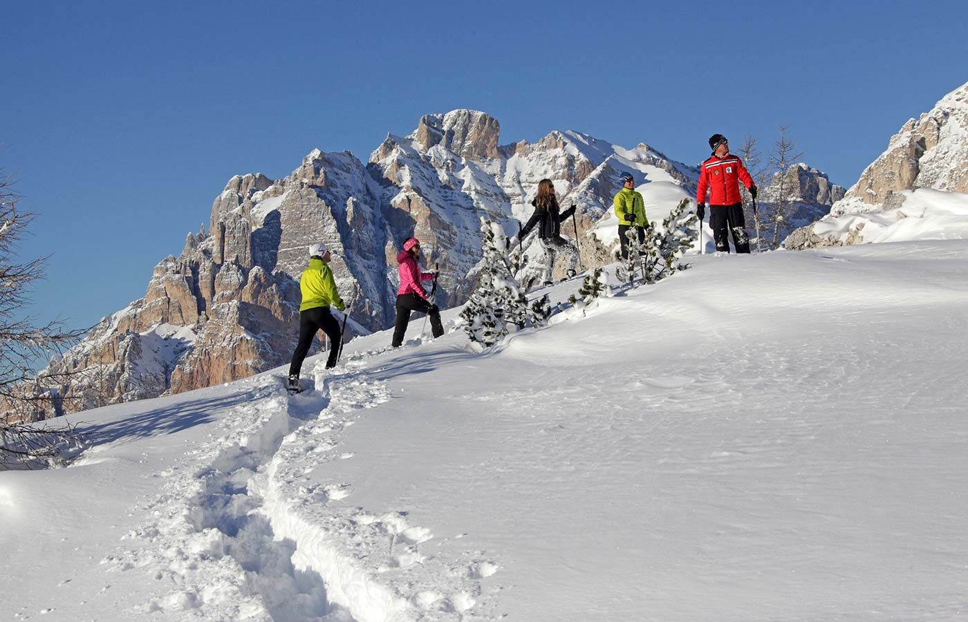 Snowshoe hiking with Dolomites at the back